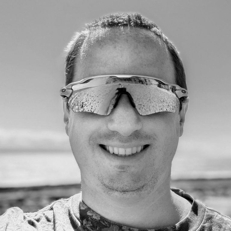 James Atter Smiling person wearing sunglasses at a scenic outdoor location.