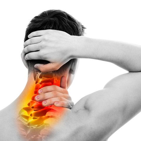 Person clutching their neck, highlighting discomfort in the cervical spine area.