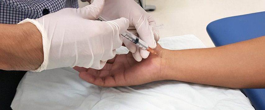 A healthcare professional administering an injection on a patient's arm.